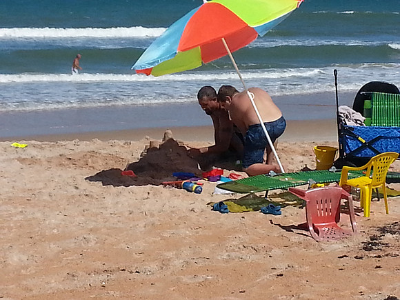 Florida Beach along A1A, people building a sand castle.